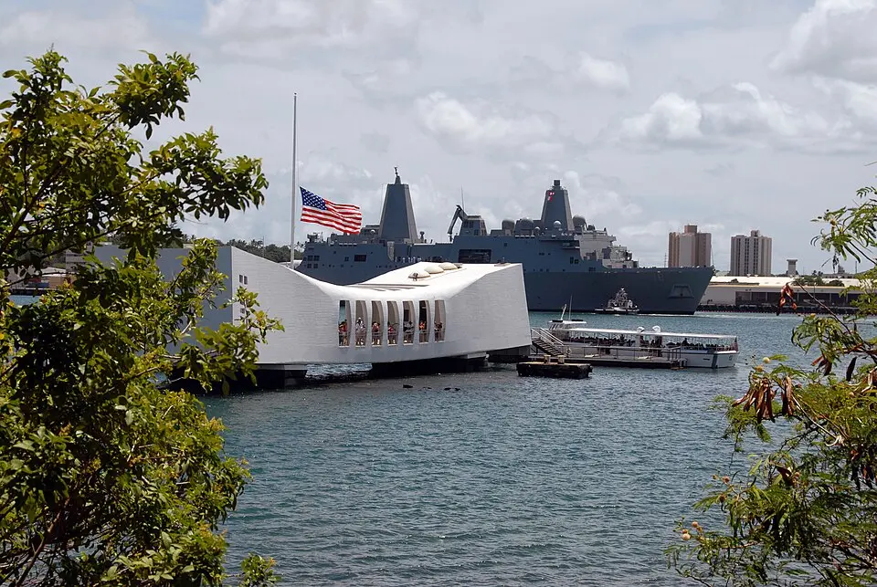 The American flag at half-staff over the USS Arizona Memorial at Pearl Harbor.